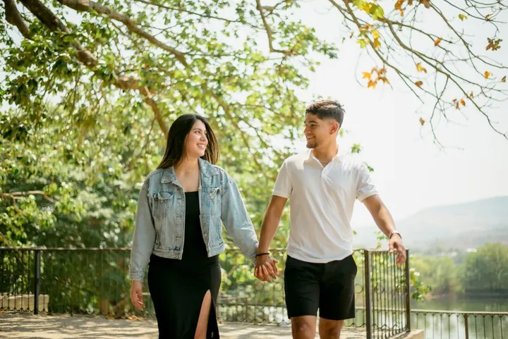 A couple walking hand in hand in a park