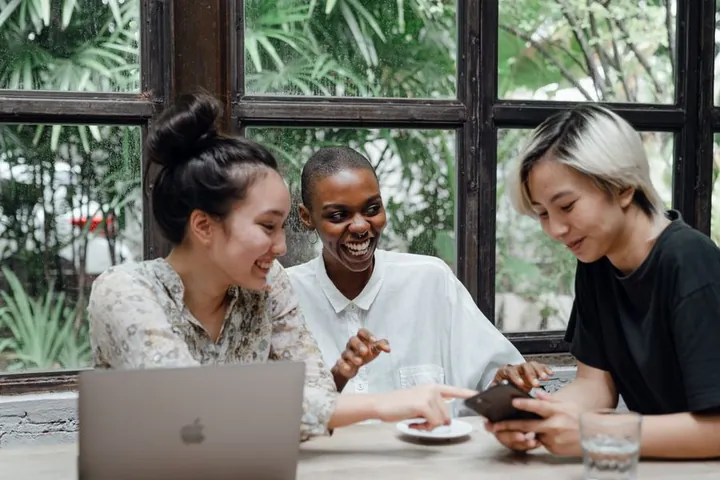 Friends laughing together at a café